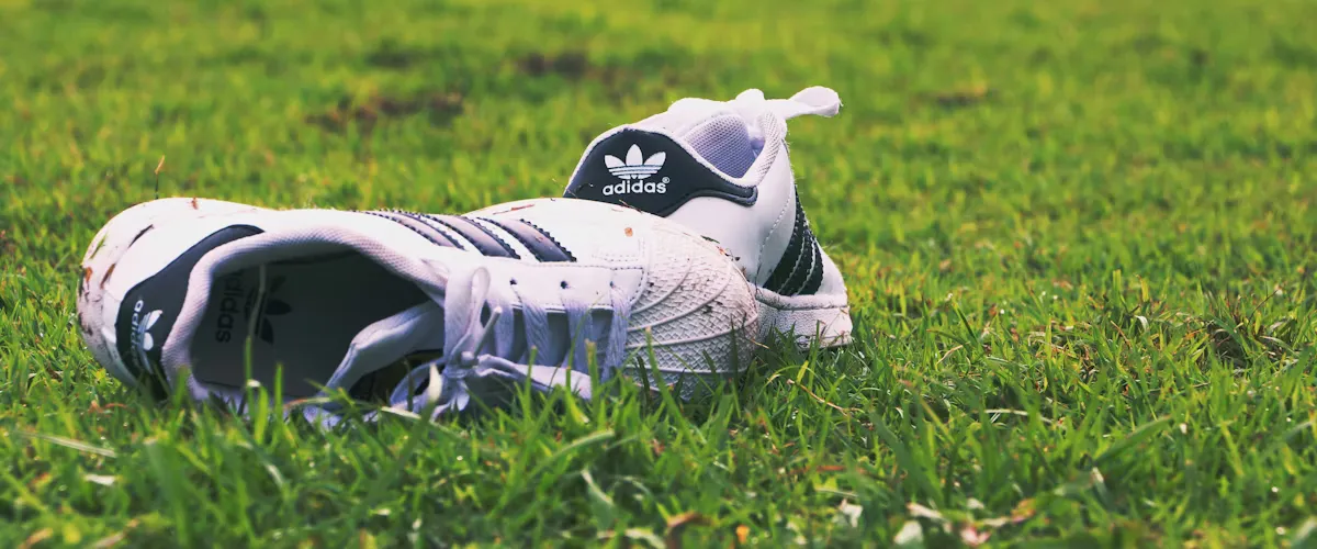 Adidas sneakers lined up on display shelf